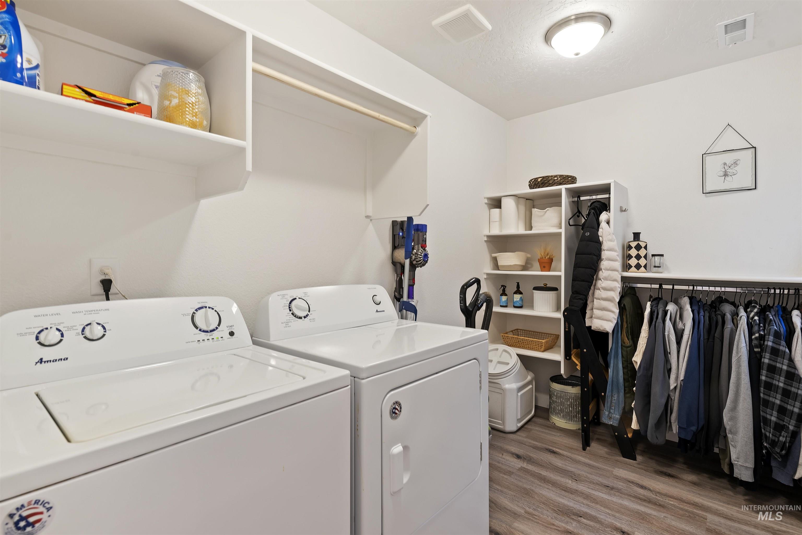 Laundry area with light wood-style flooring and independent washer and dryer