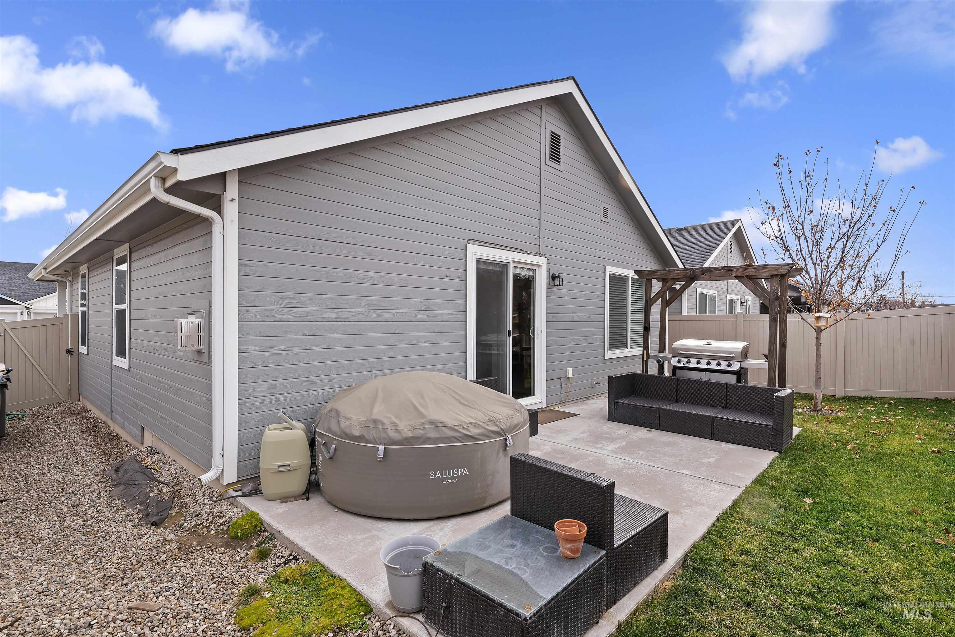 Rear view of property with a fenced backyard, a patio area, and outdoor lounge area