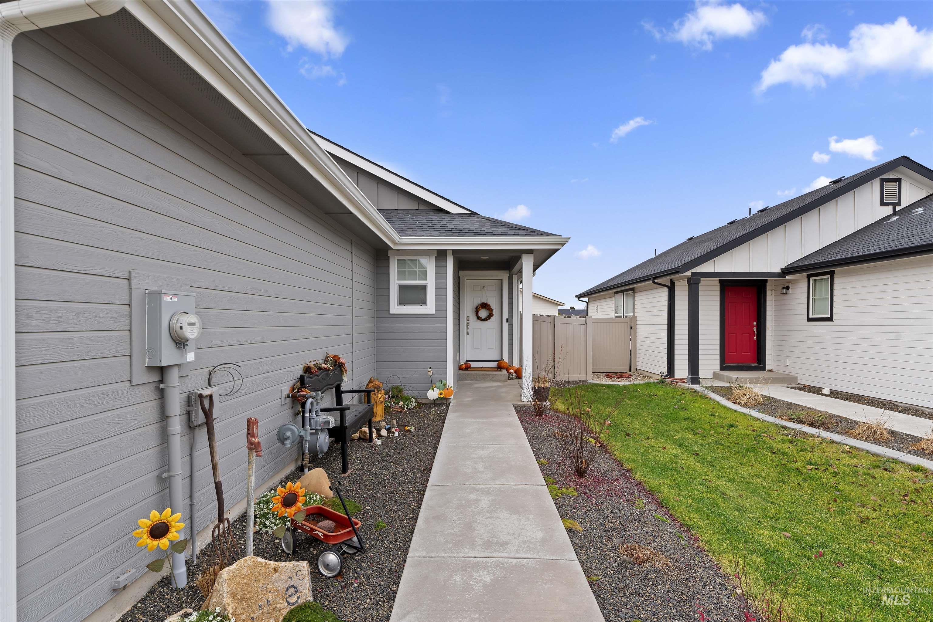 Entrance to property with roof with shingles and board and batten siding