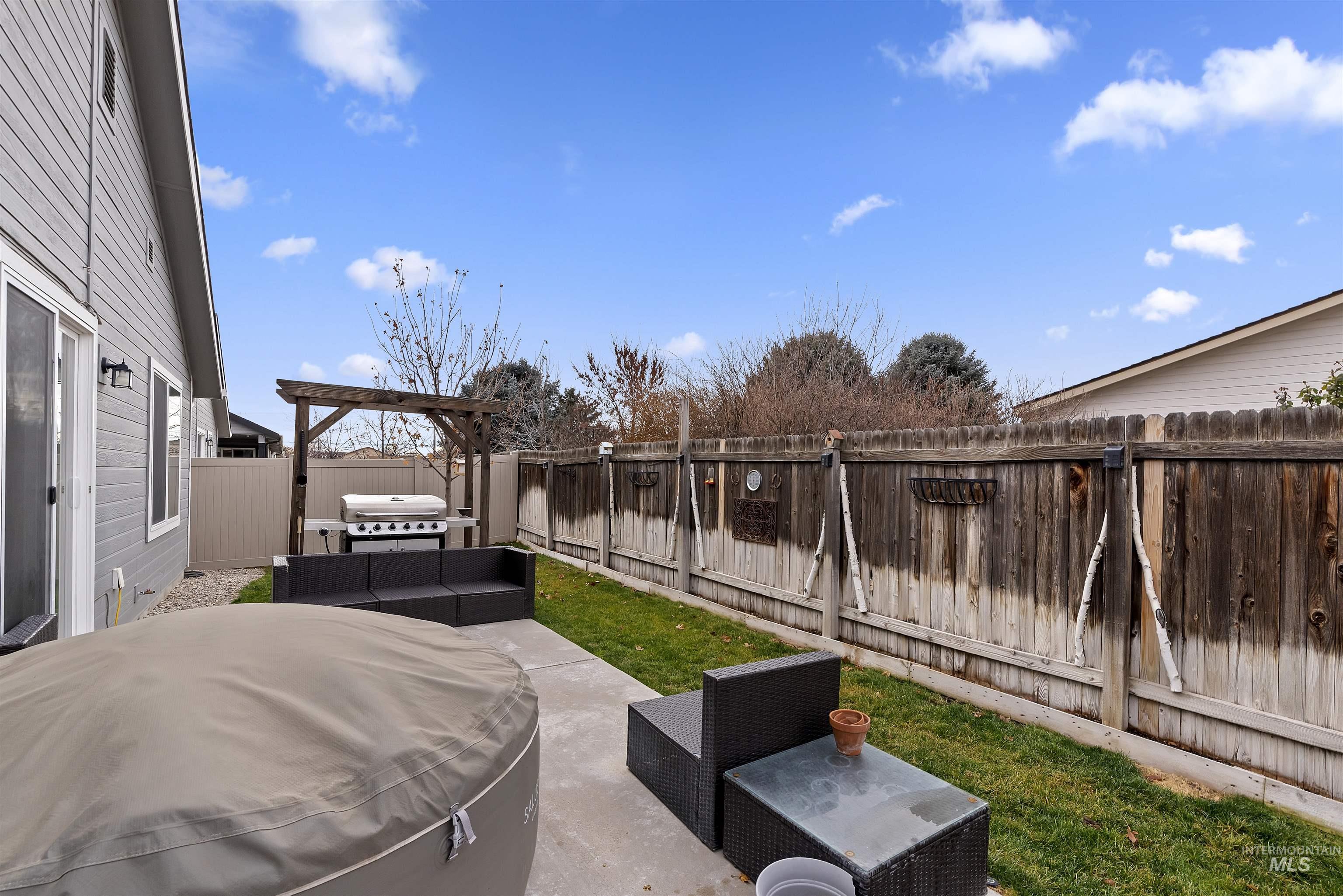Fenced backyard with a patio area, outdoor lounge area, and area for grilling