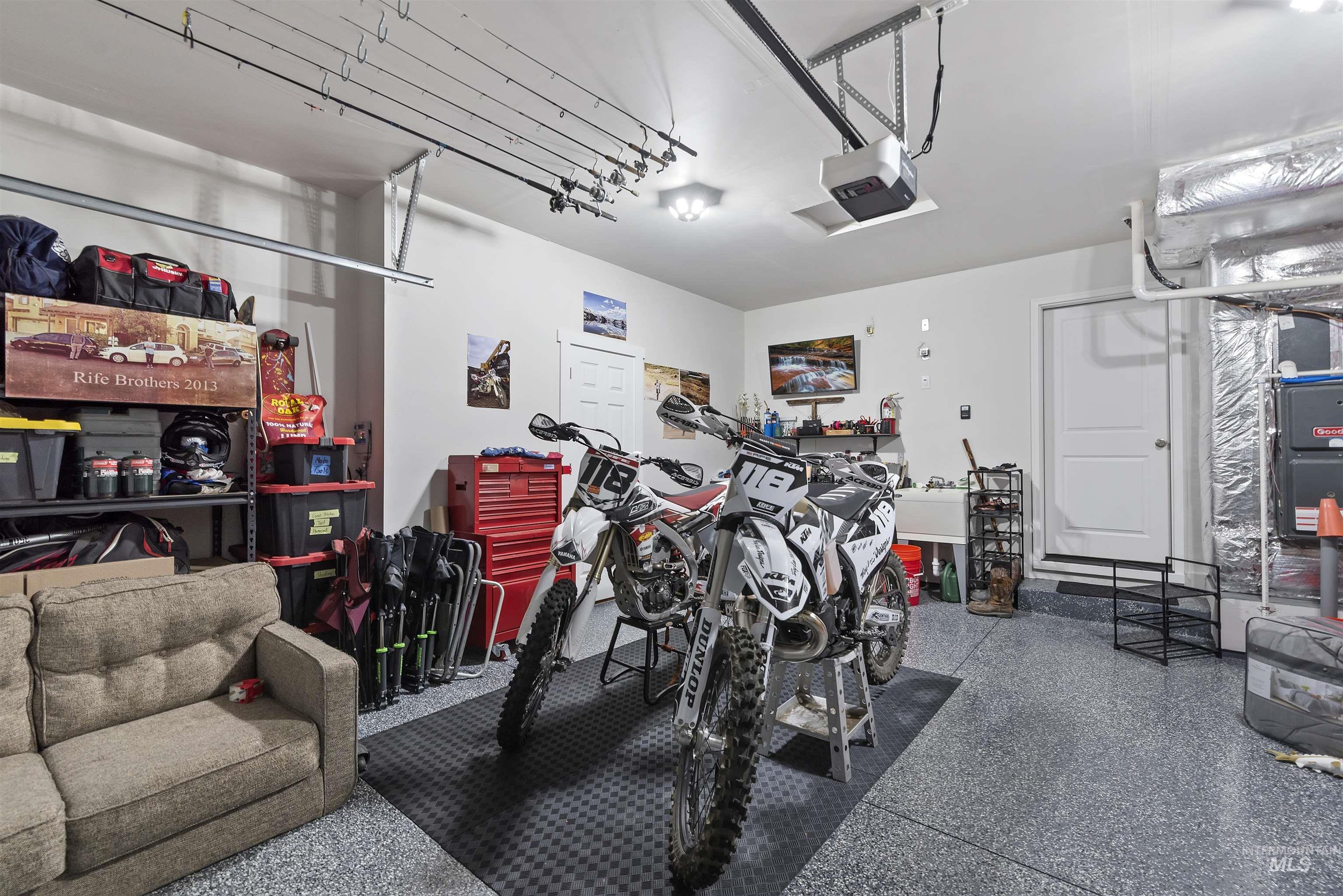 Garage featuring a garage door opener and heating unit