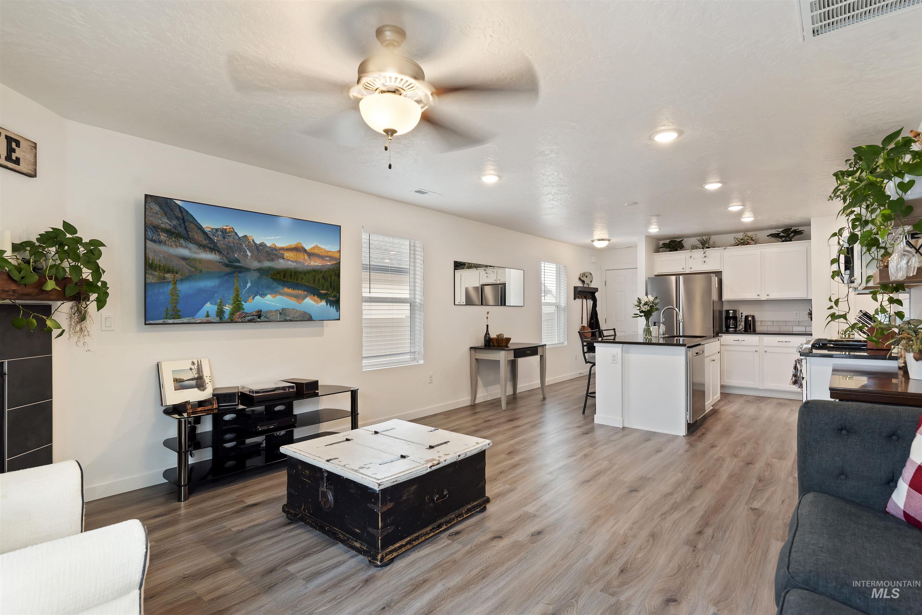Living area featuring a ceiling fan and light wood-type flooring