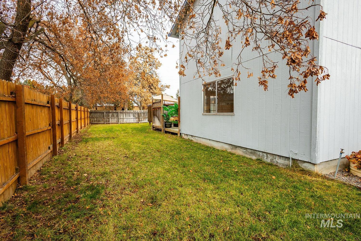 Fenced backyard featuring a wooden deck