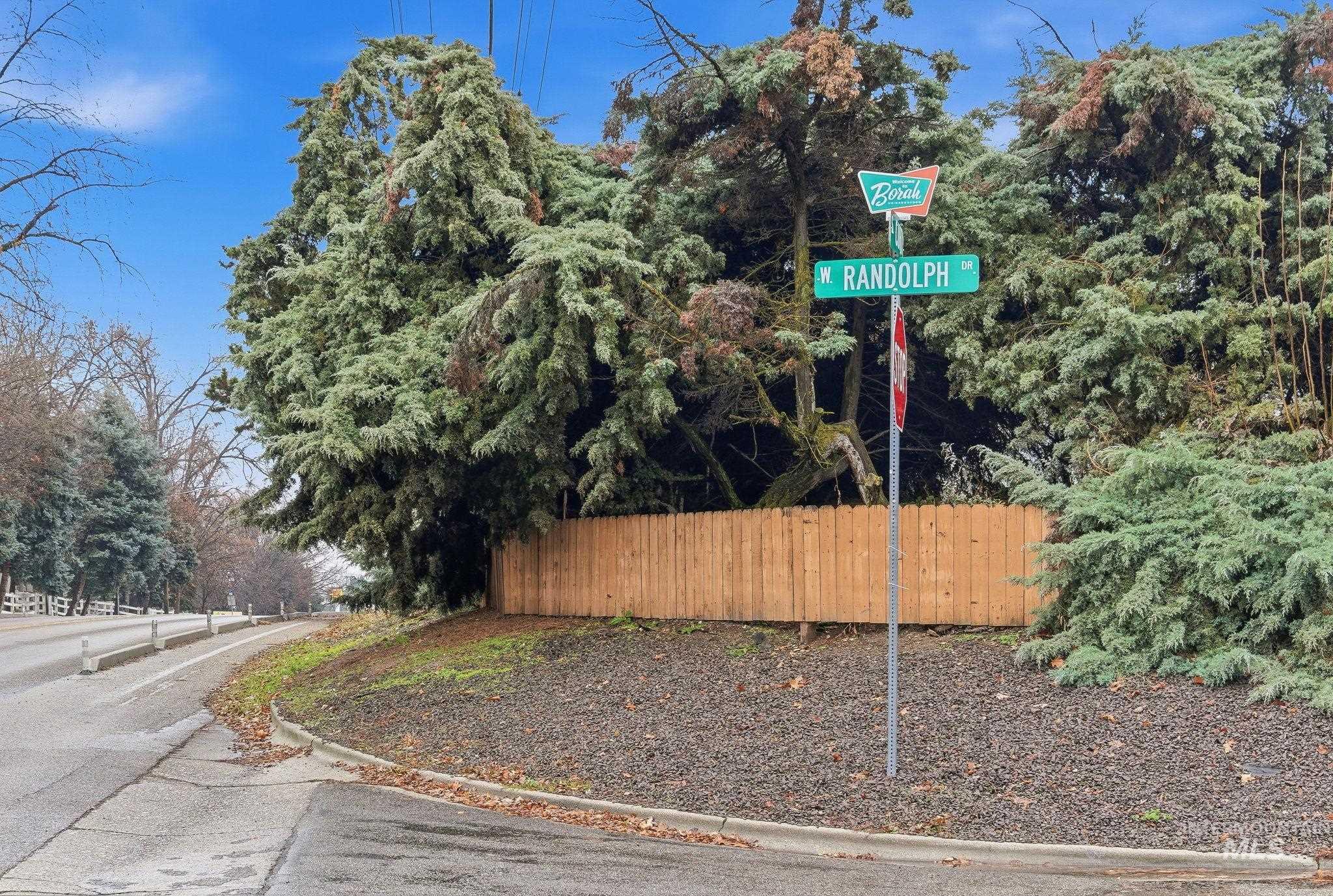 View of asphalt road featuring curbs