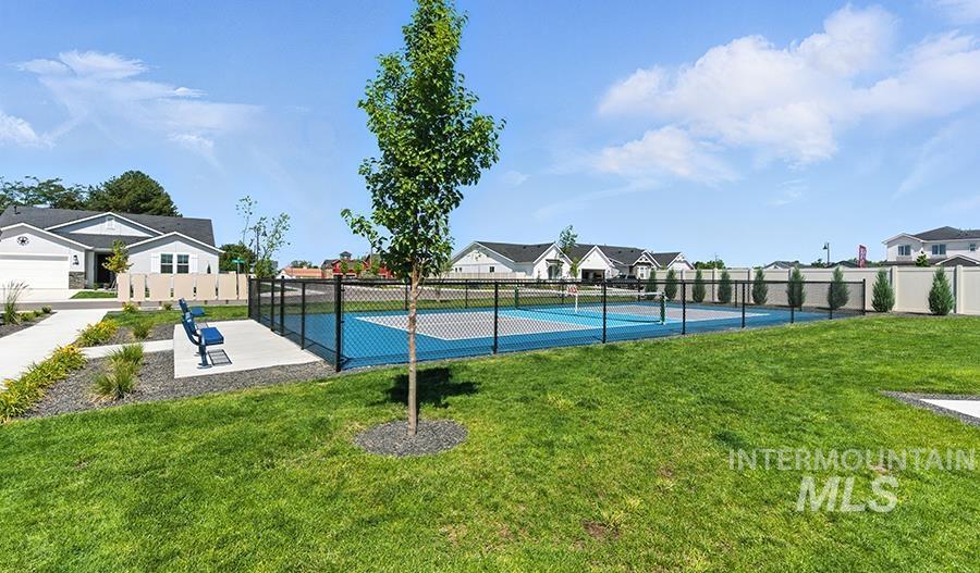 View of basketball court with a tennis court and a residential view