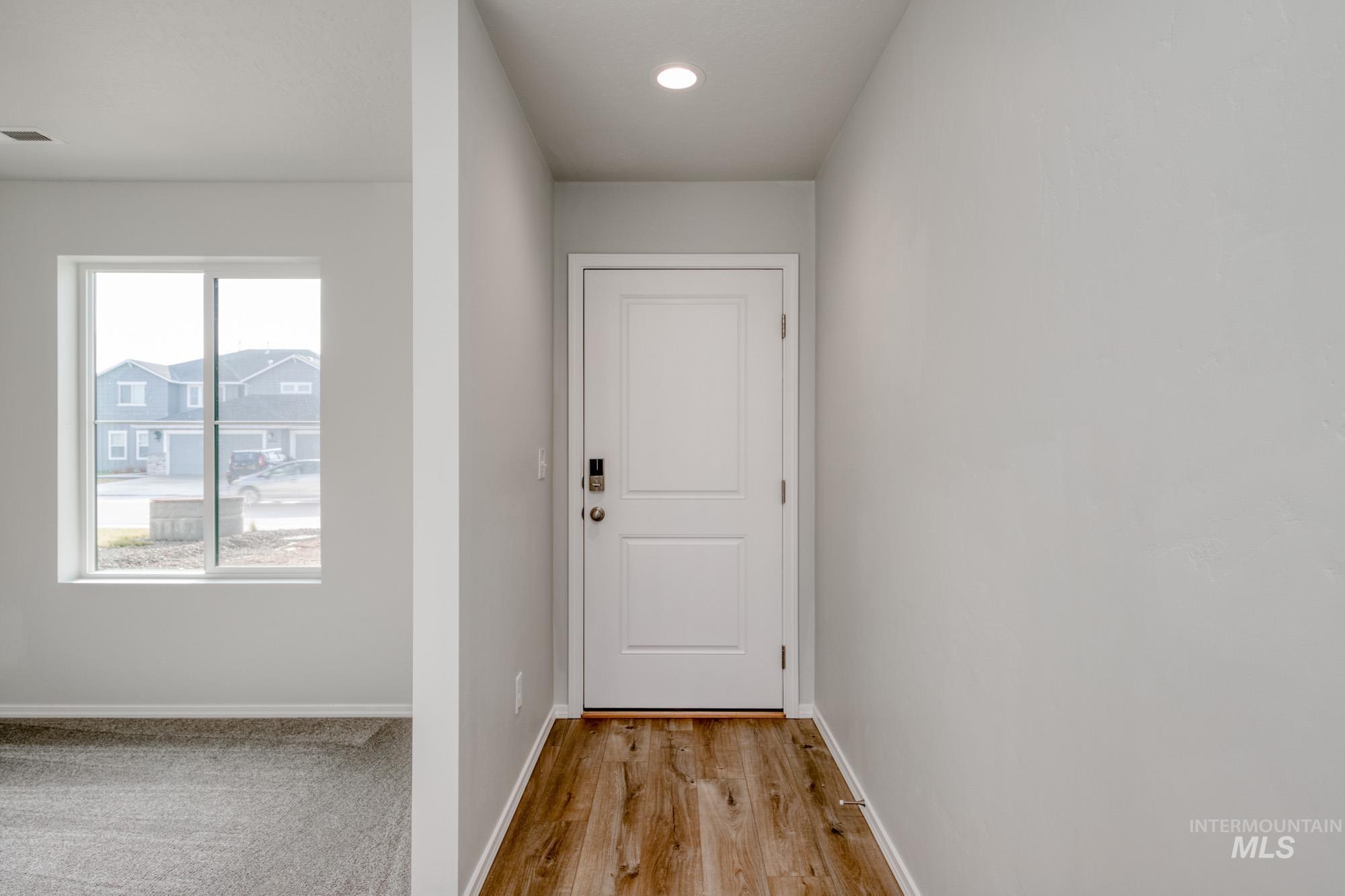 Doorway to outside featuring wood finished floors and recessed lighting