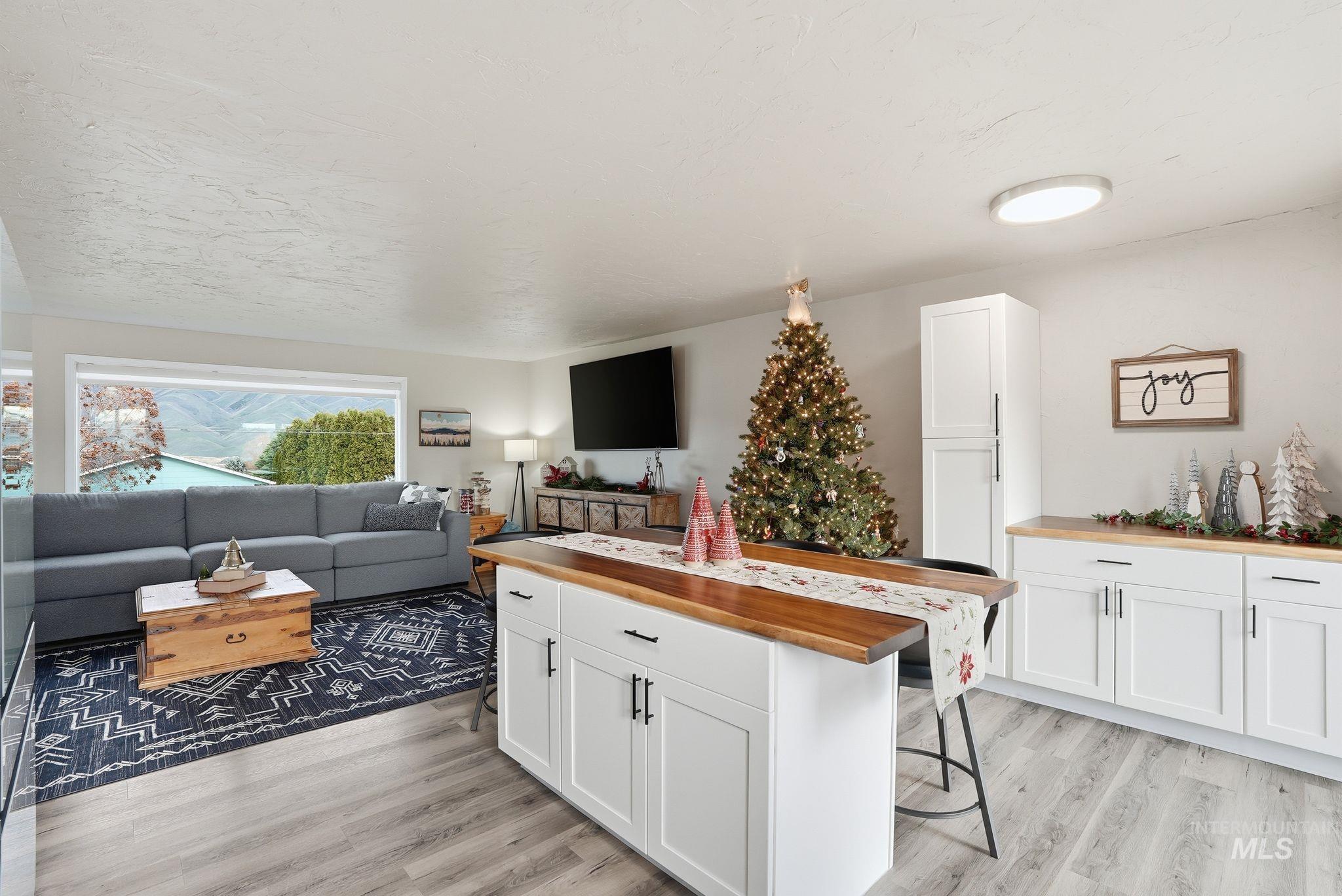 Living room with light wood-style flooring