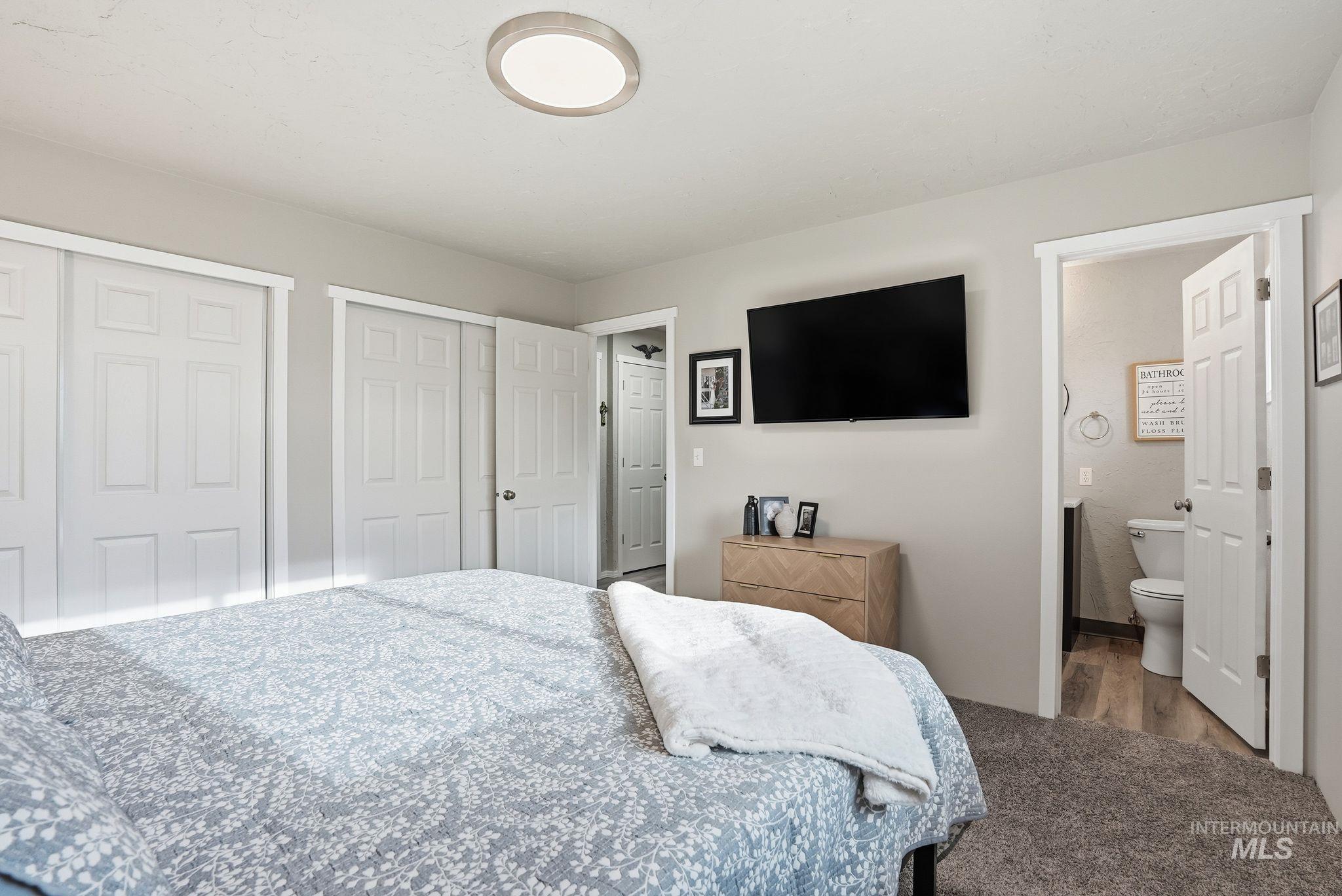 Bedroom featuring two closets and carpet
