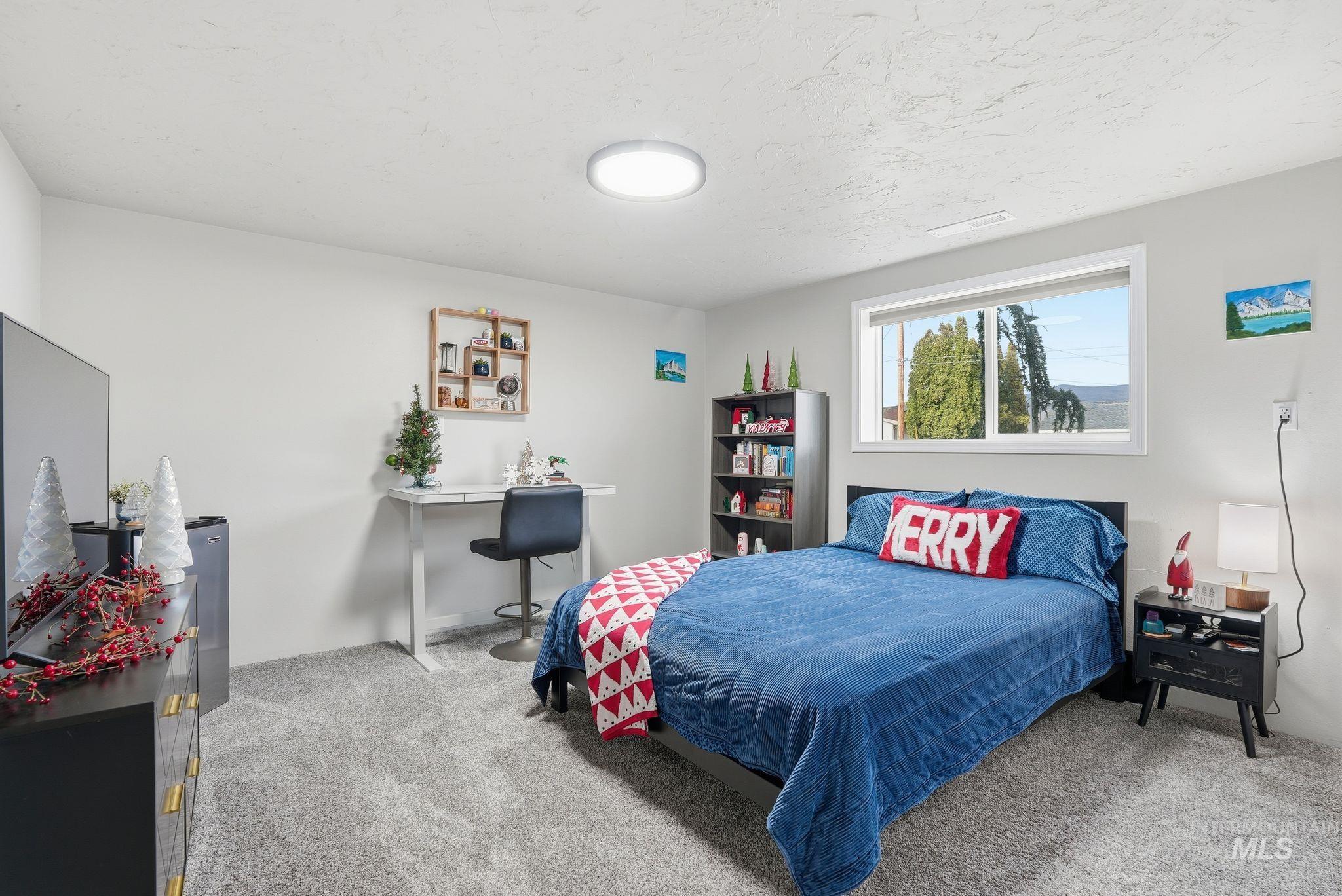 Carpeted bedroom with a textured ceiling