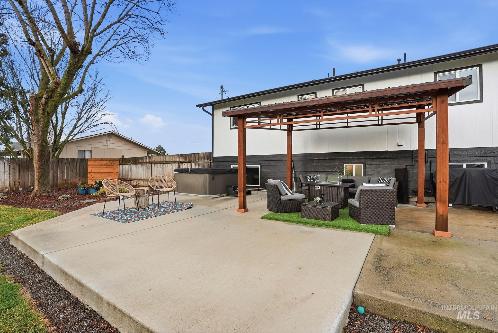 View of patio with a gazebo, area for grilling, an outdoor hangout area, and a hot tub