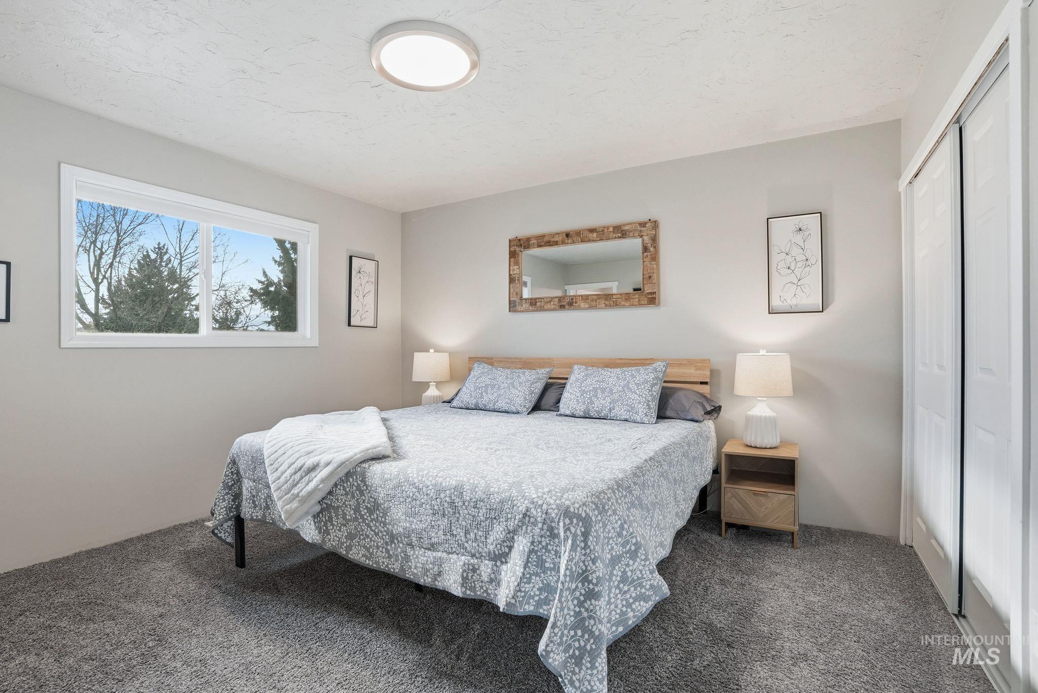 Bedroom featuring carpet flooring and a closet