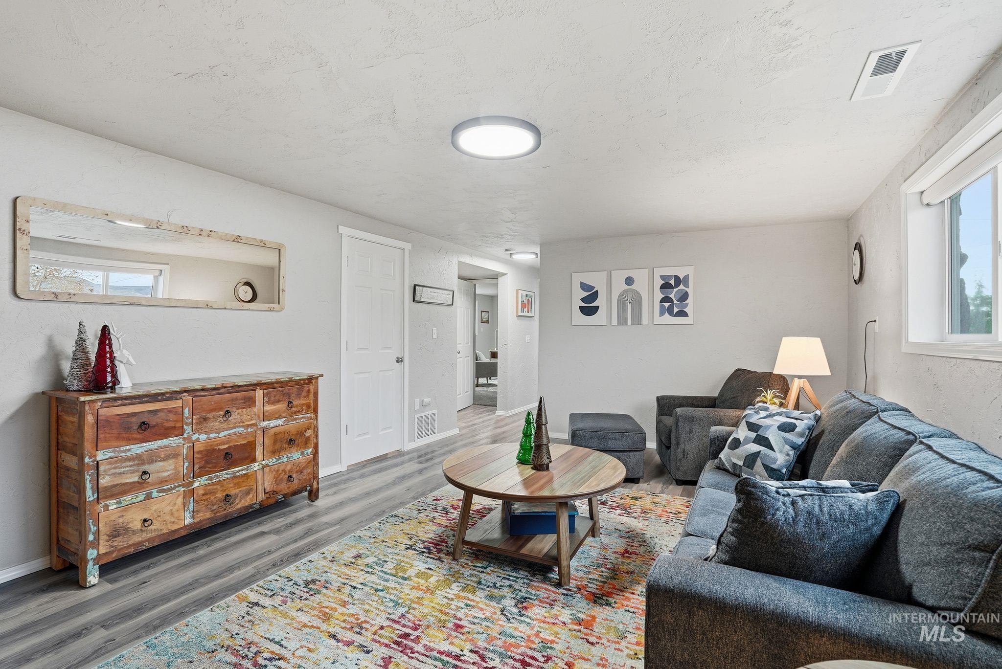 Living area with wood finished floors and a textured ceiling