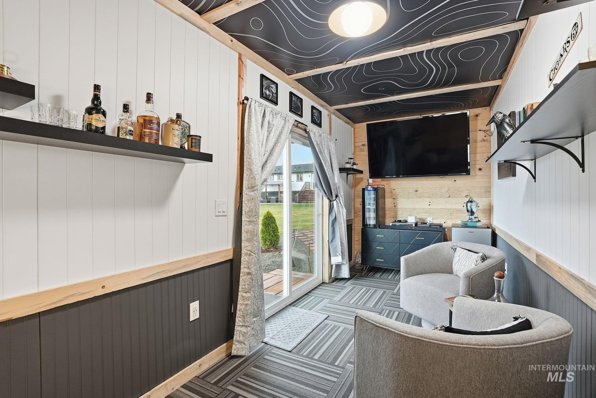 Living room with wood walls and carpet flooring