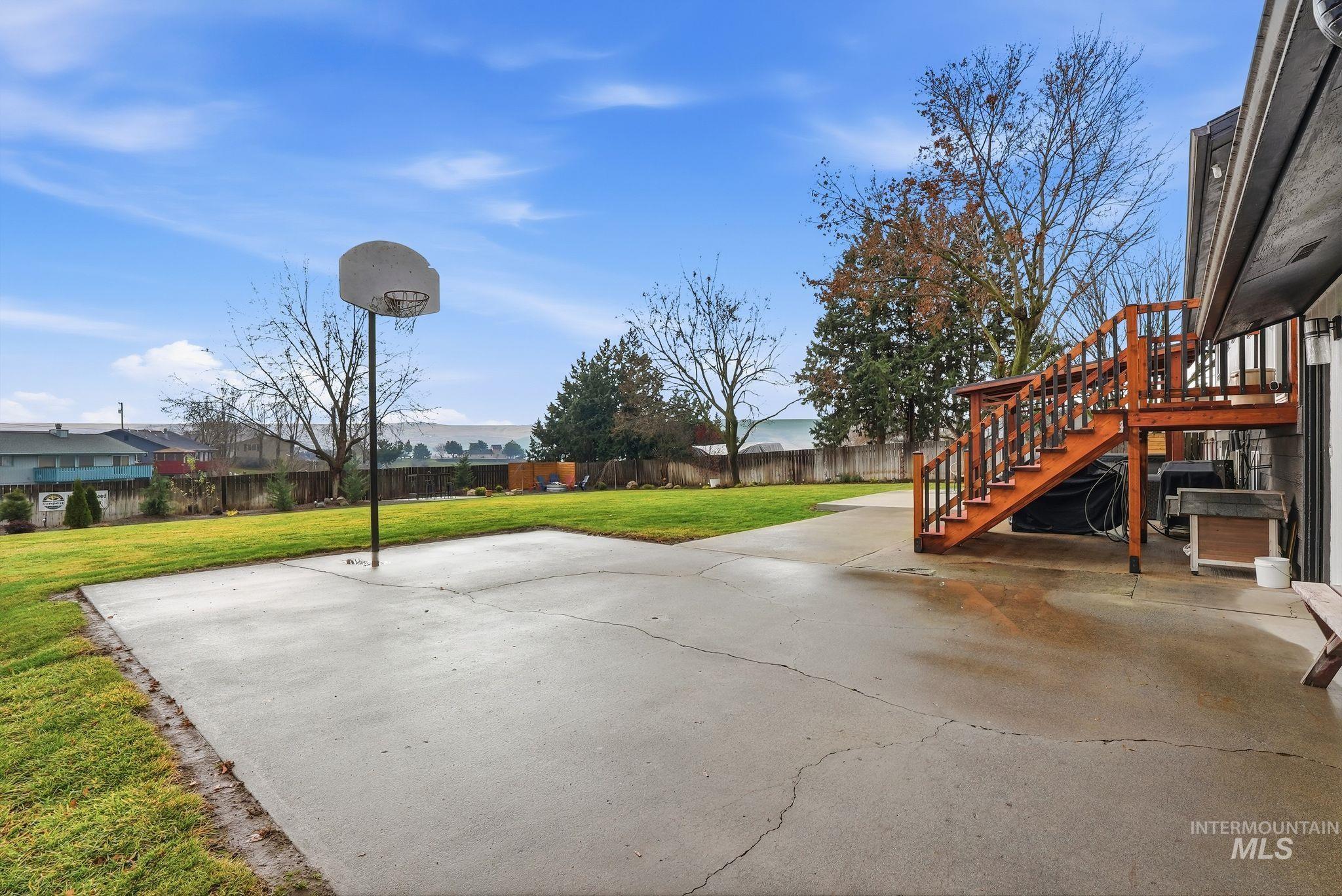 Fenced backyard with stairs and a patio