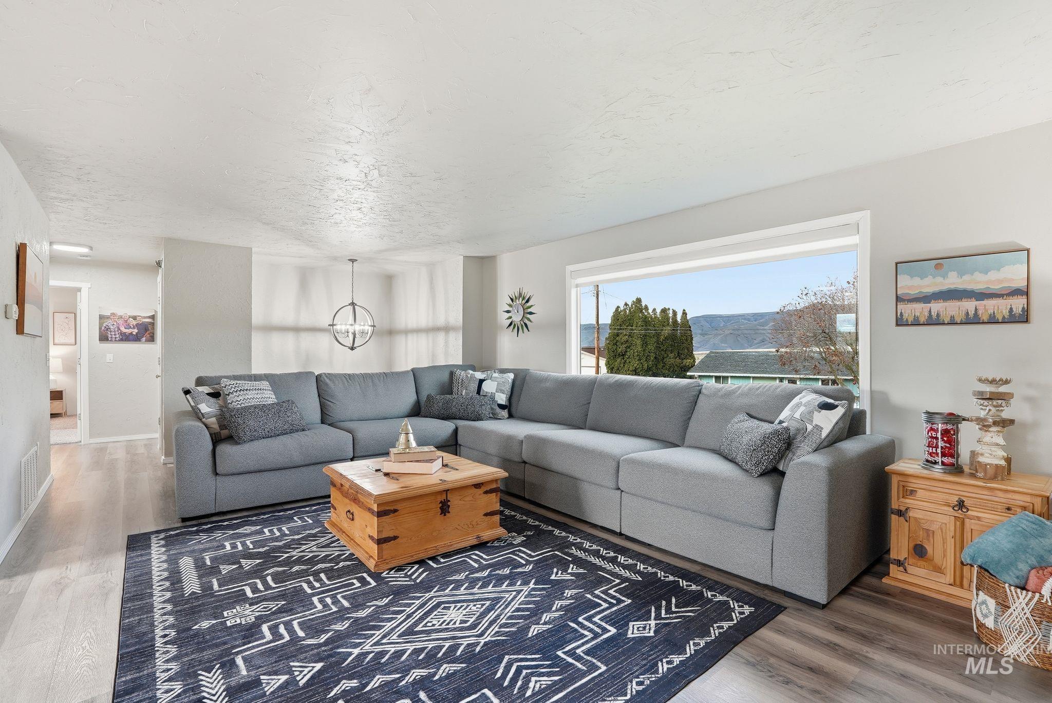 Living area featuring wood finished floors and a textured ceiling