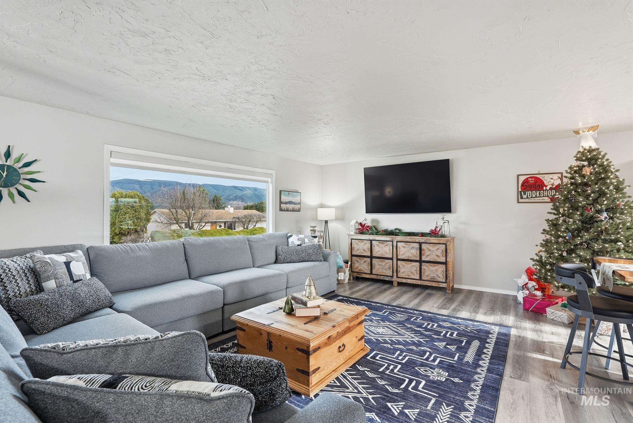 Living room featuring wood finished floors and a textured ceiling