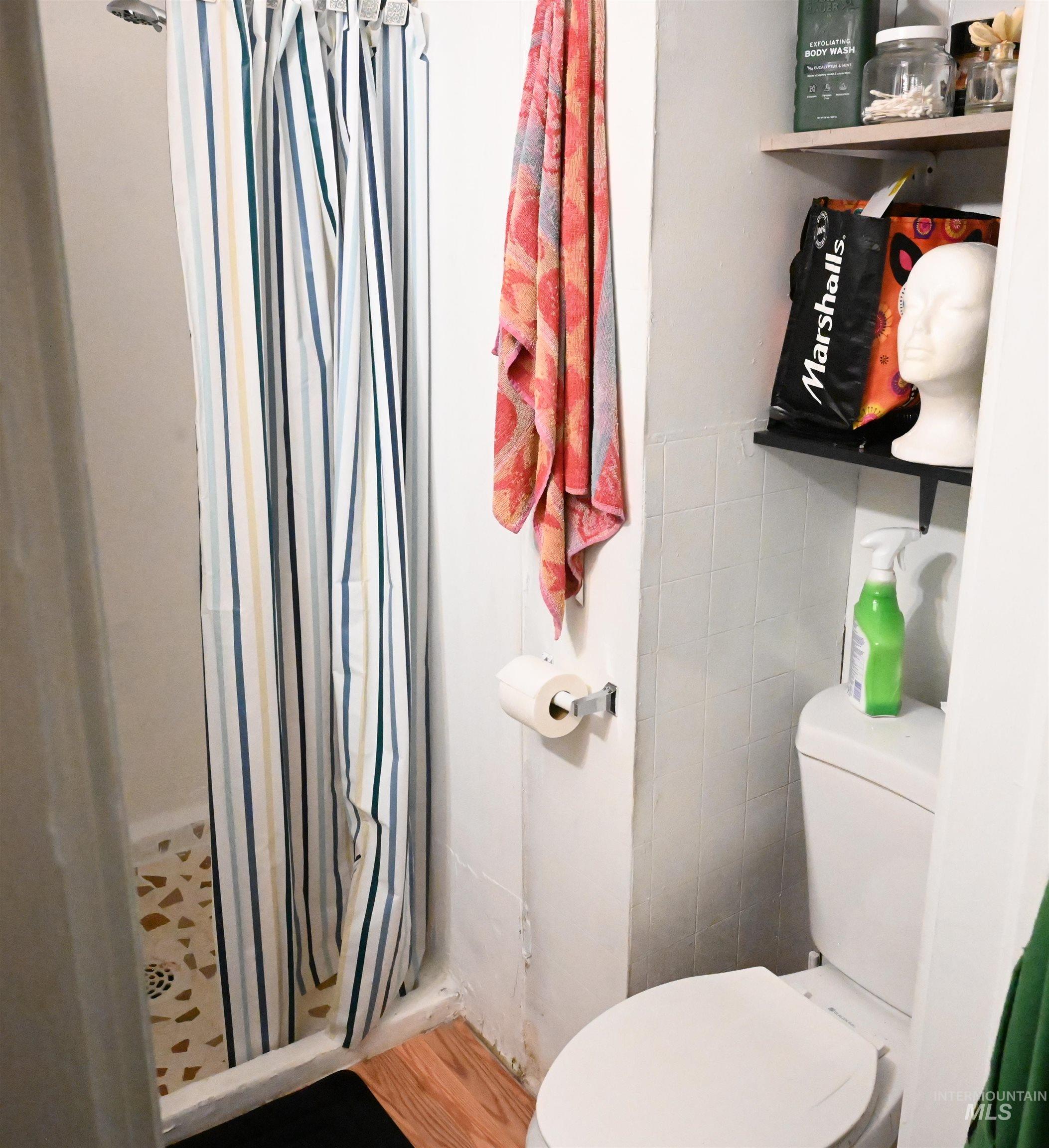 Full bathroom with a stall shower and toilet