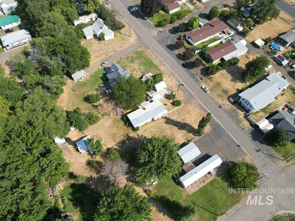 Aerial view of property and surrounding area with nearby suburban area