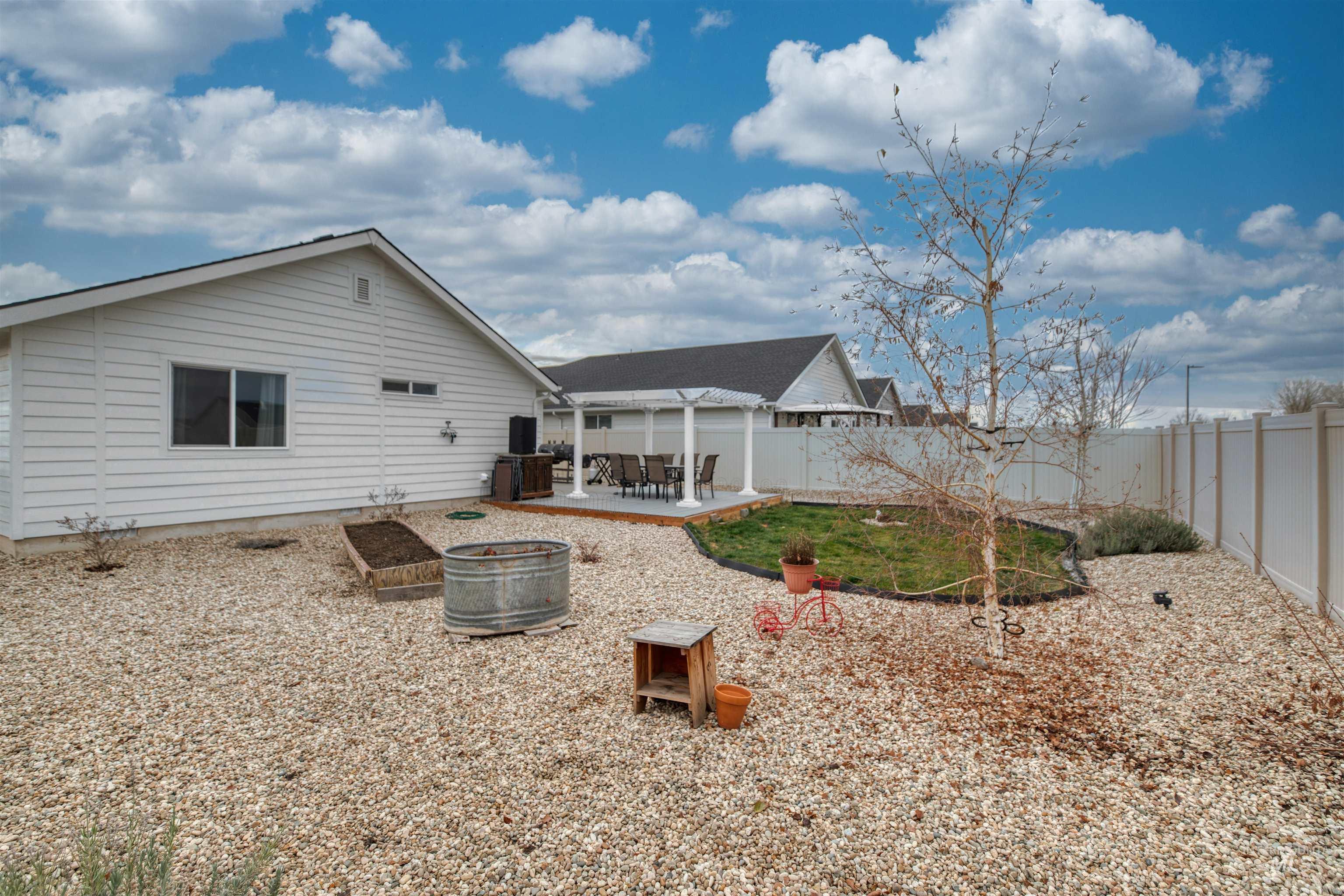 Rear view of property with a patio area and a fenced backyard