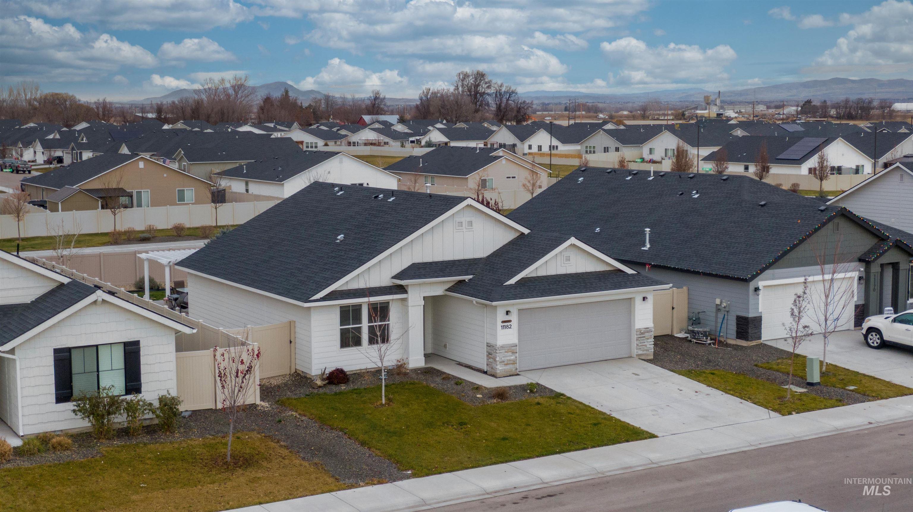 Aerial perspective of suburban area with a mountainous background