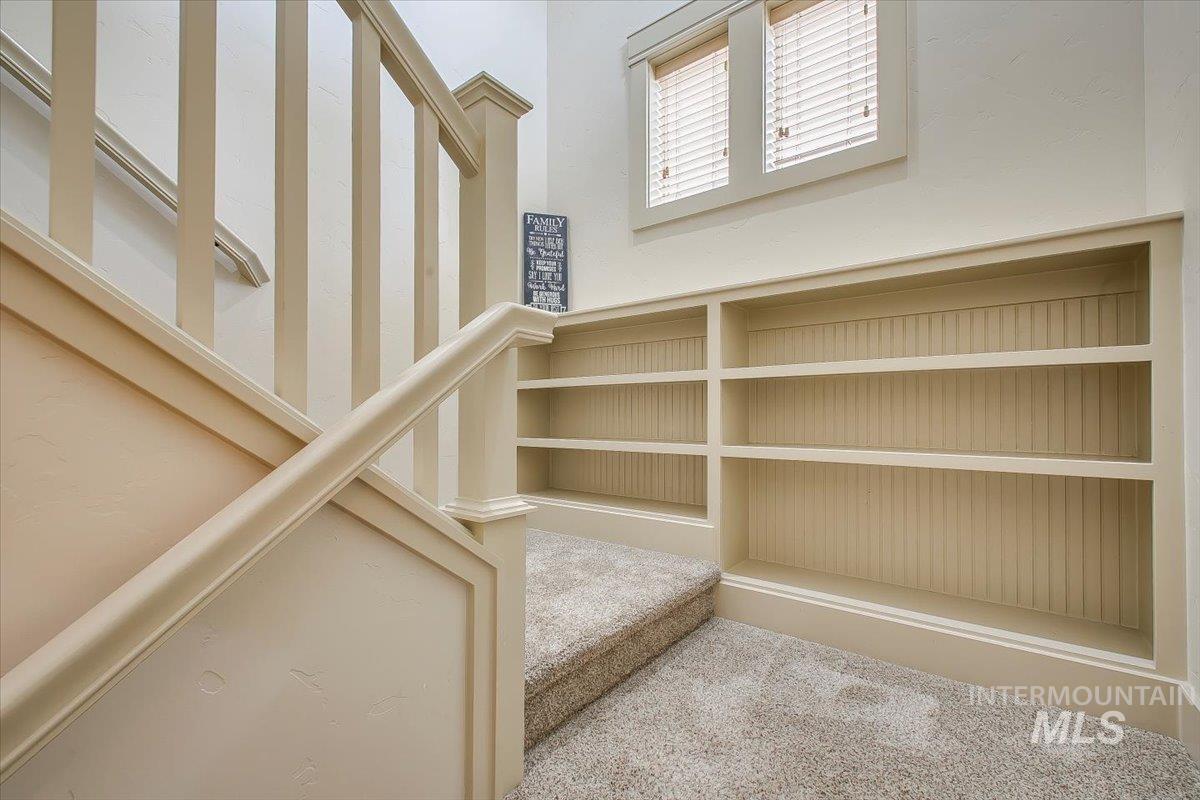 Stairway featuring carpet floors