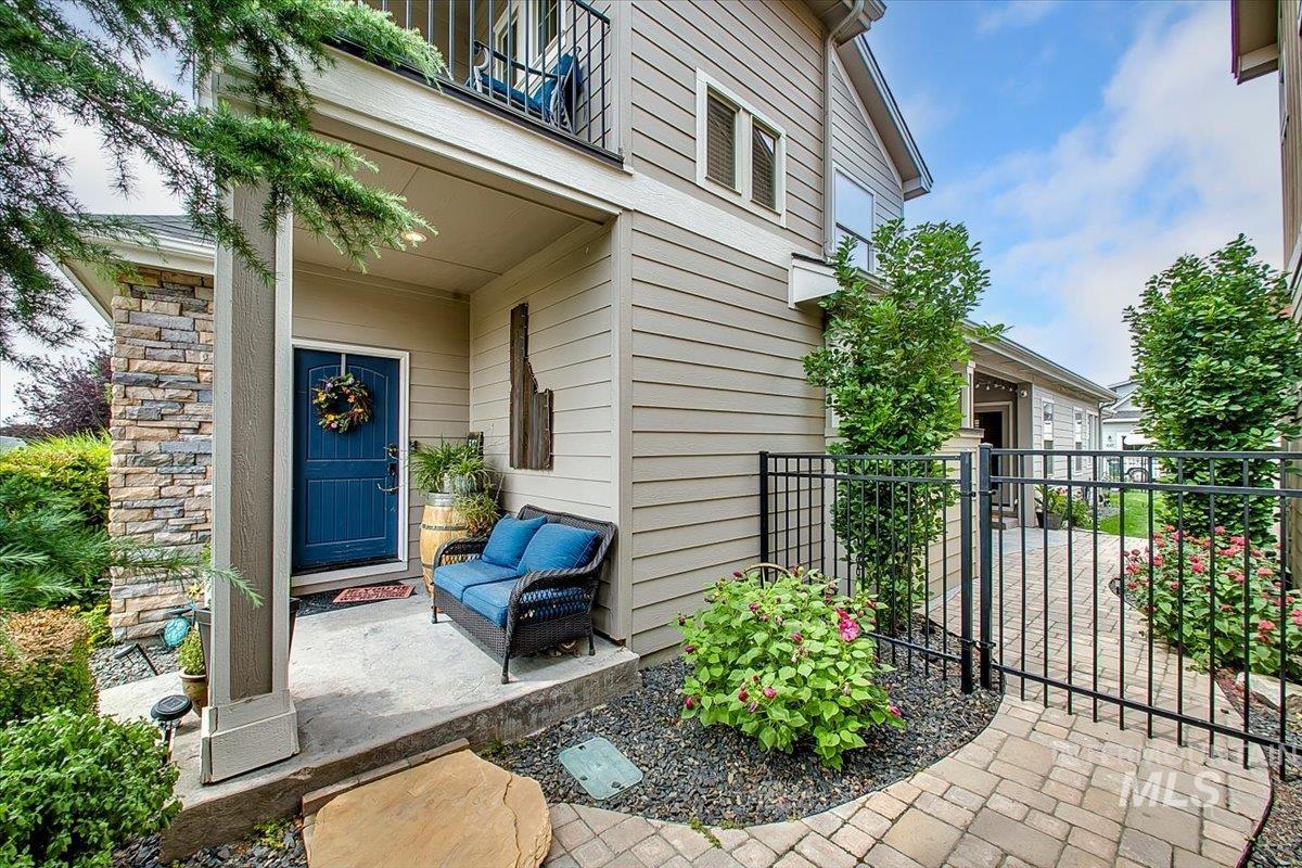 Property entrance featuring a gate and stone siding
