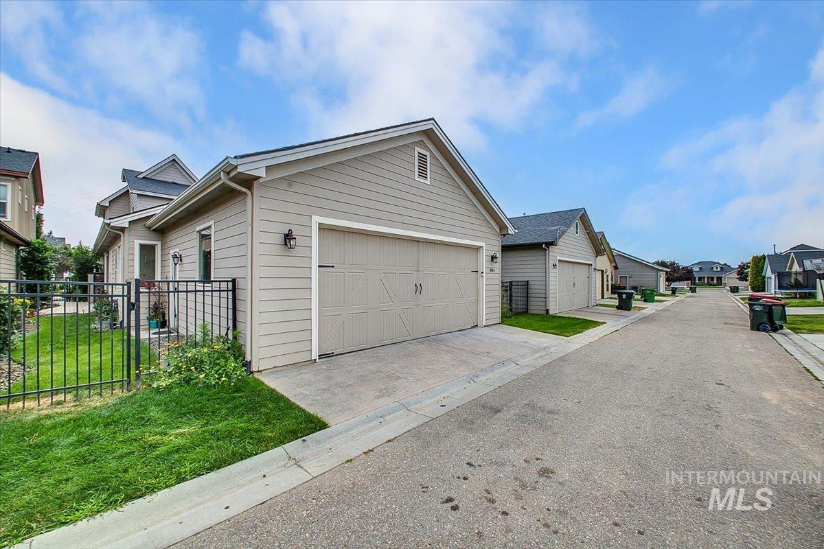 View of front of home featuring a residential view, an attached garage, and driveway