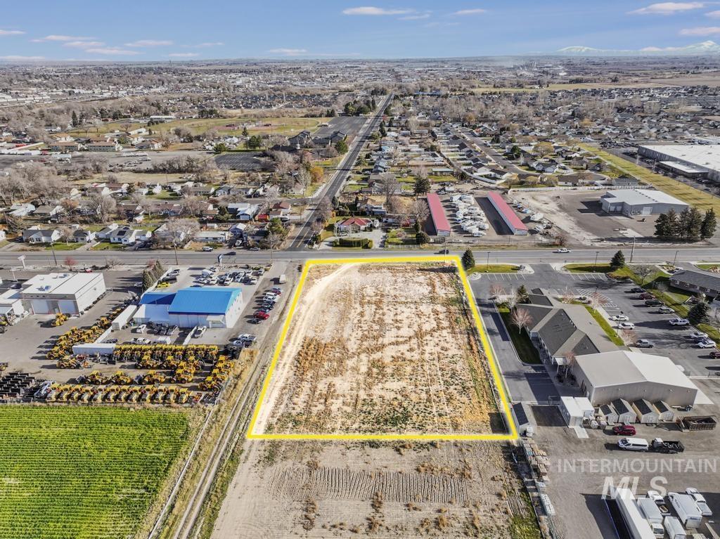 Aerial view of property and surrounding area featuring property parcel outlined