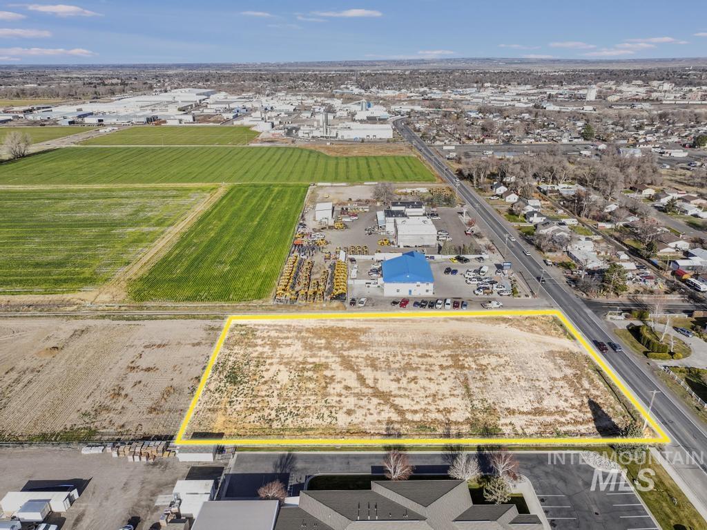 Aerial view of property's location with property parcel outlined and abundant farmland