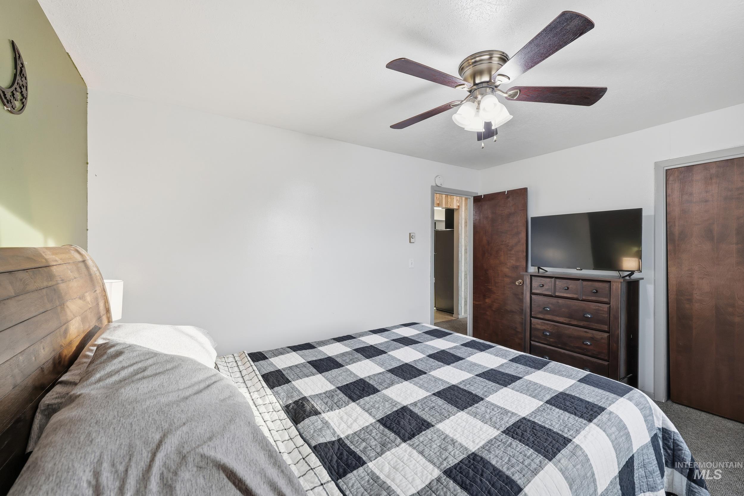 Bedroom featuring a ceiling fan, carpet floors, and a closet