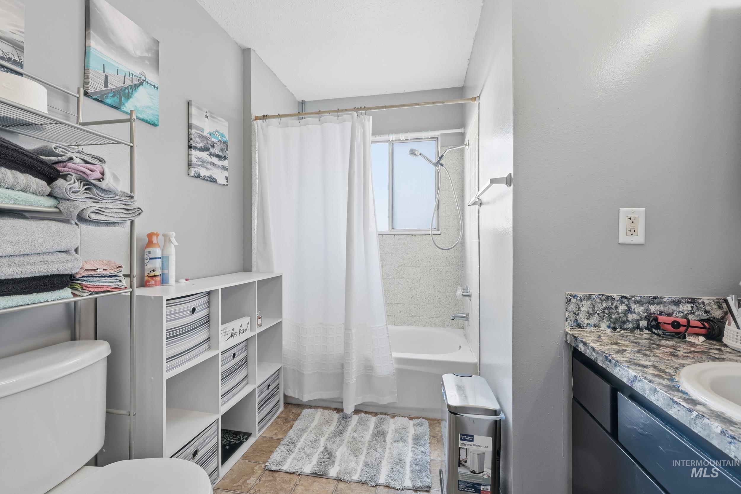 Full bath featuring shower / tub combo with curtain and vanity