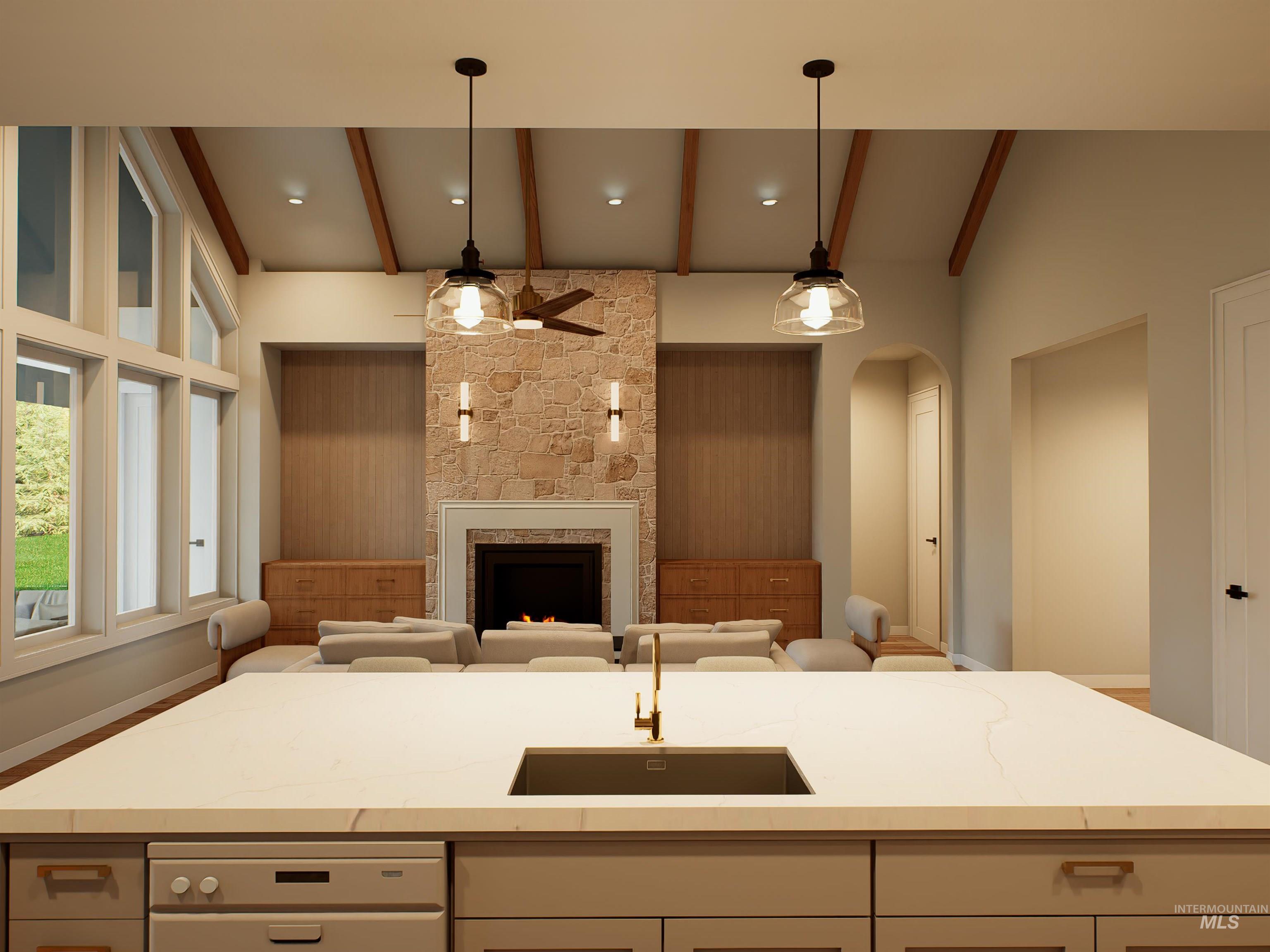 Kitchen featuring a fireplace, an island with sink, light stone countertops, ceiling fan, and arched walkways