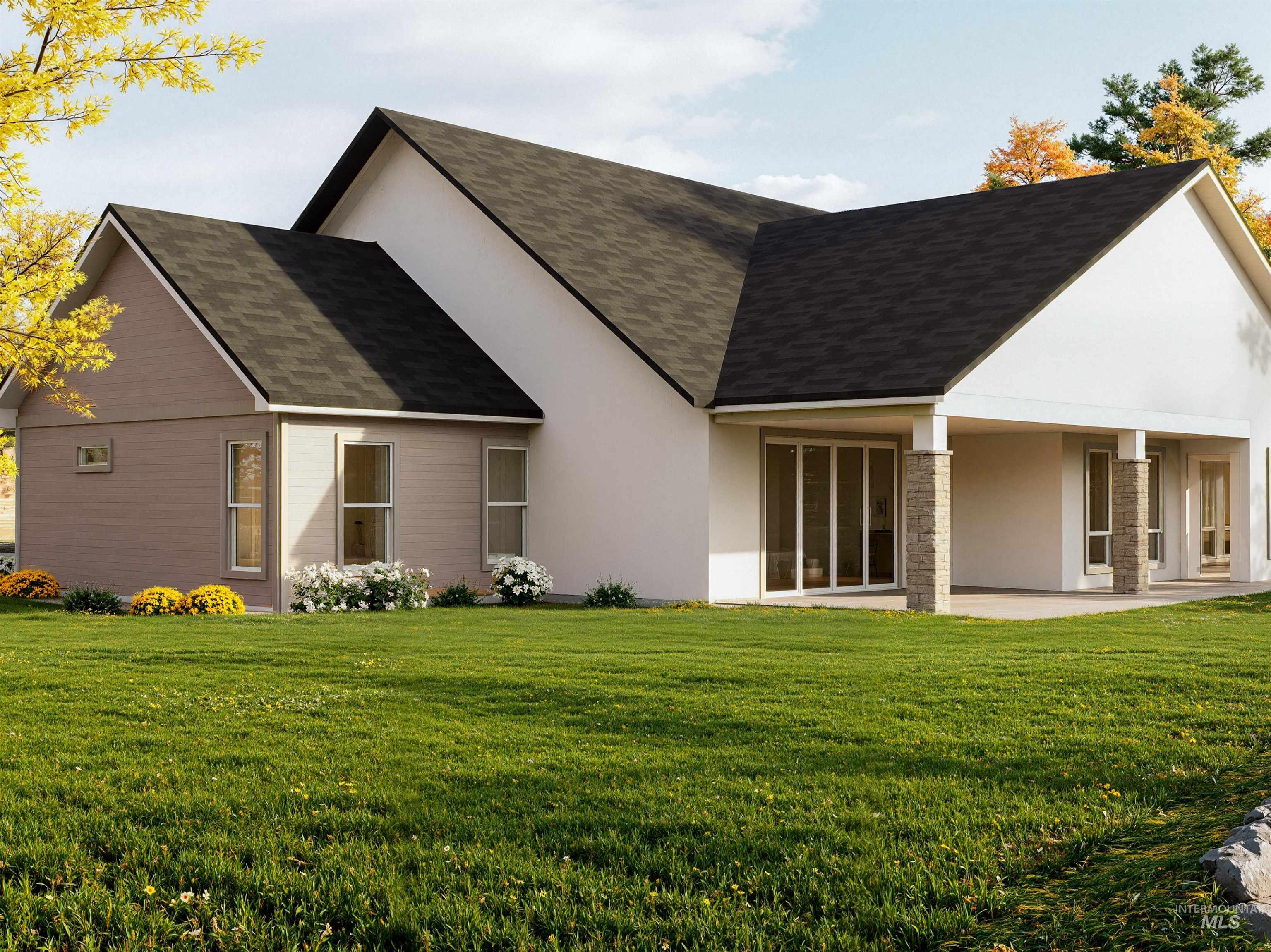 Rear view of property with stucco siding, a lawn, a patio area, and a shingled roof