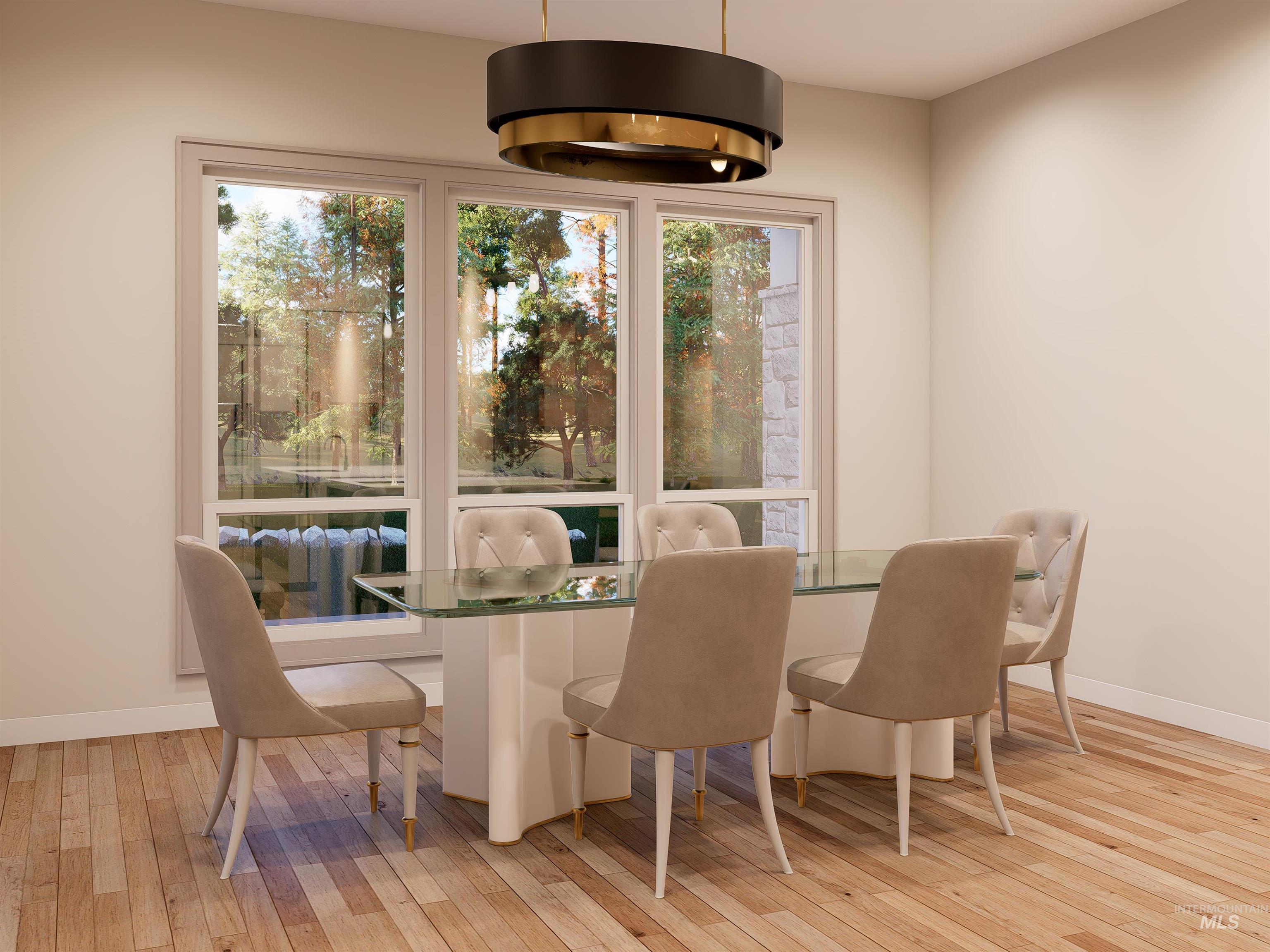 Dining room with light wood-style flooring and healthy amount of natural light