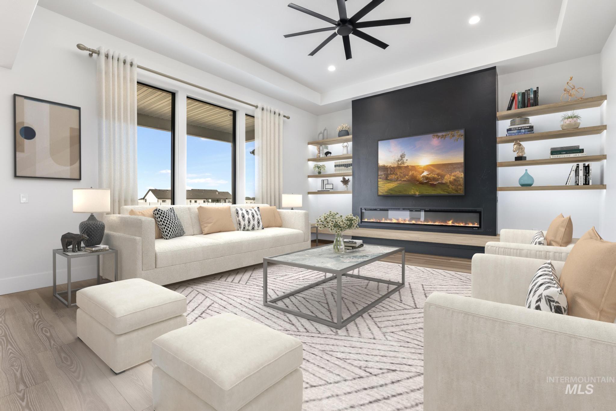 Living area with light wood-style floors, a glass covered fireplace, ceiling fan, and recessed lighting