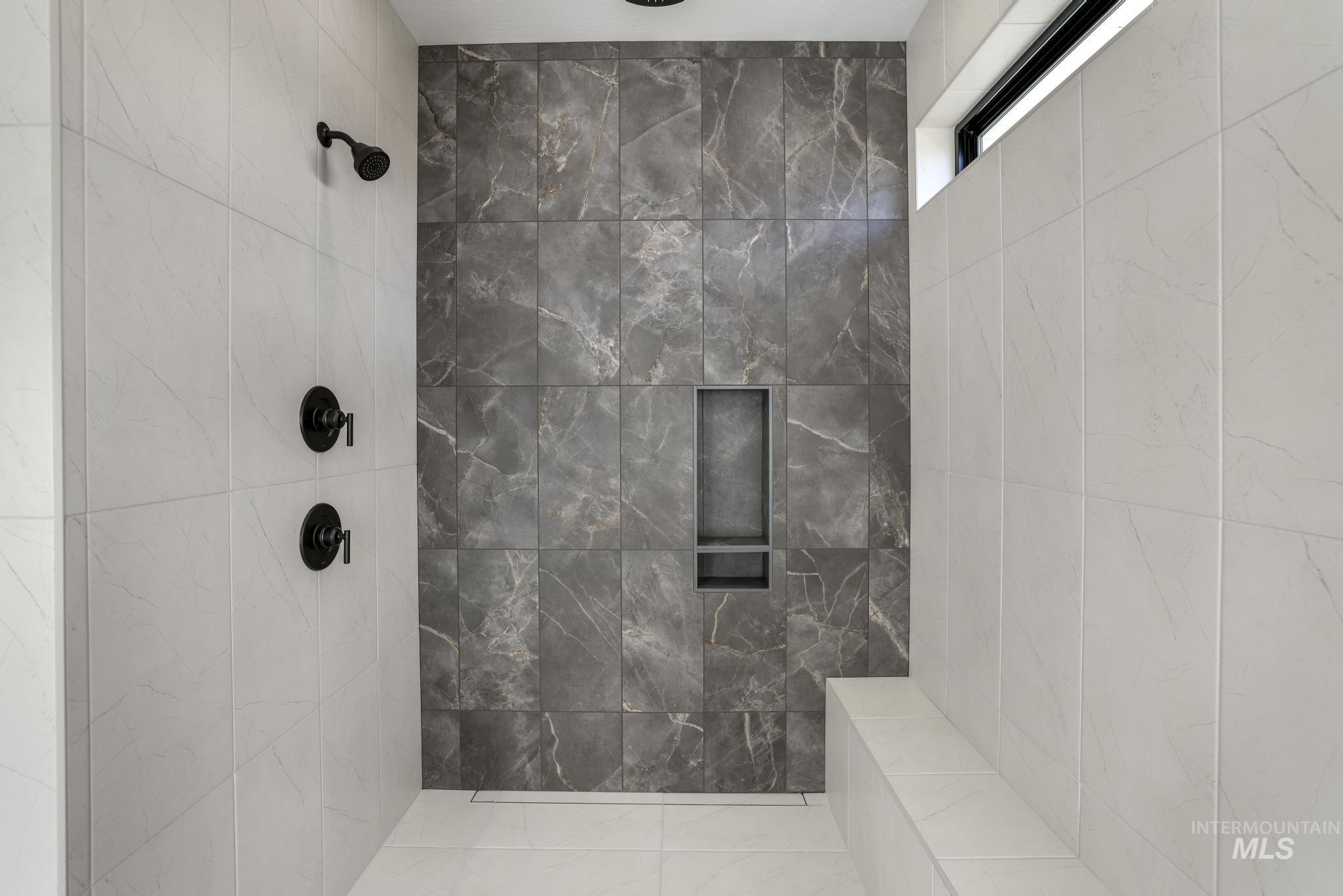 Bathroom featuring a tile shower