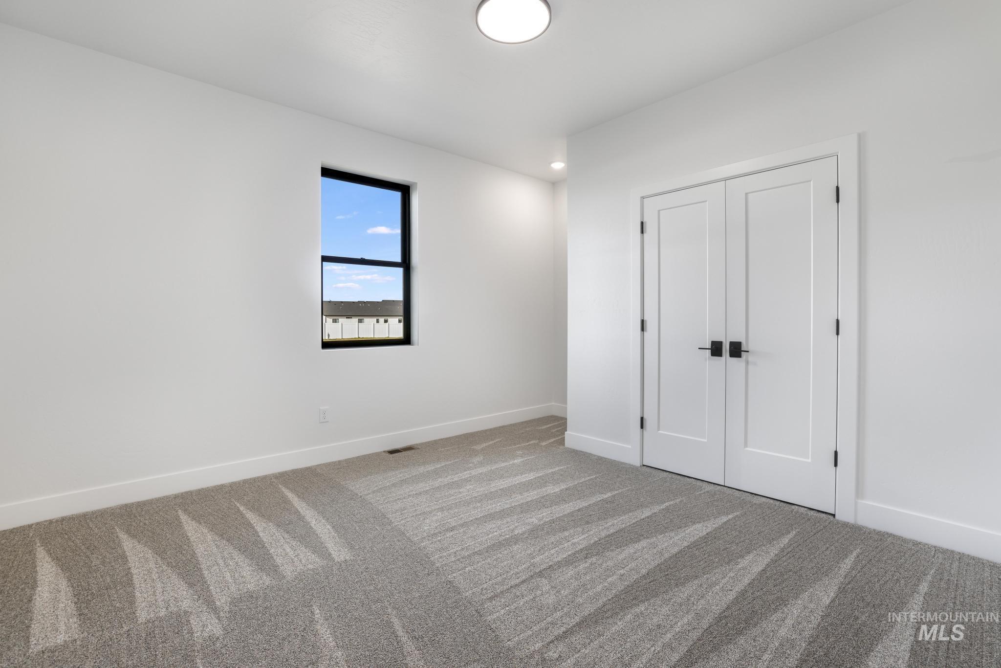 Unfurnished bedroom with a closet, carpet floors, and recessed lighting