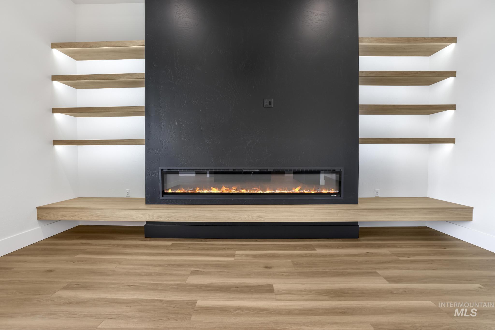 Detailed view of a fireplace and wood finished floors