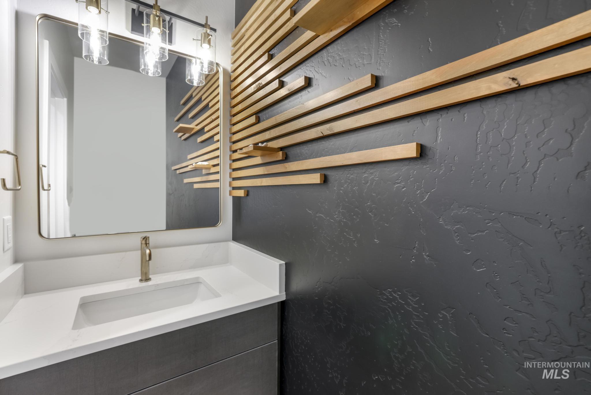 Bathroom with vanity and a textured wall