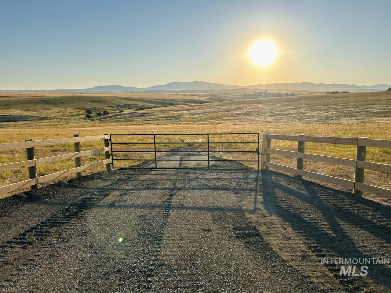 Gate with a mountain view and a rural view