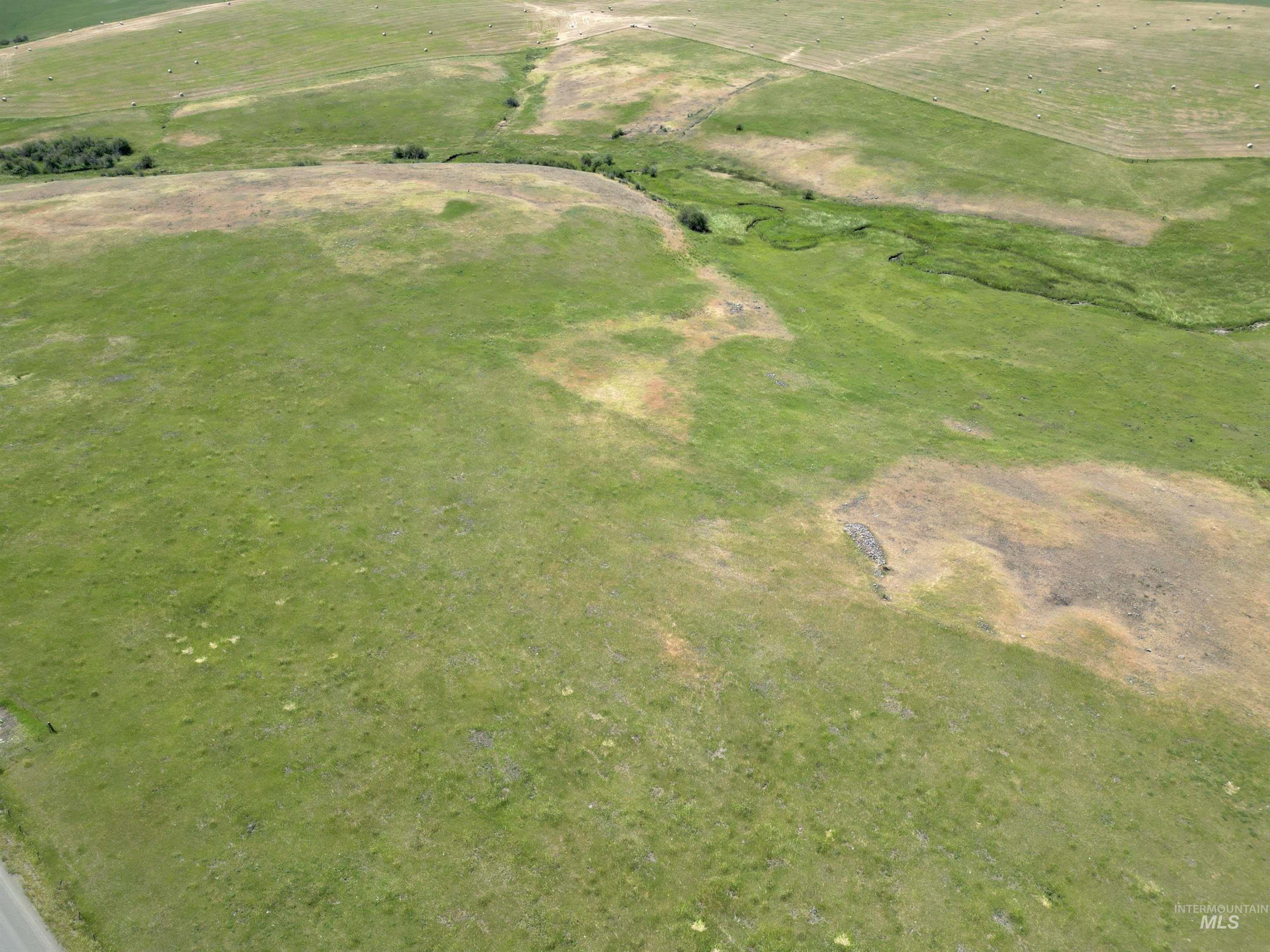 Aerial view of property and surrounding area featuring rural landscape