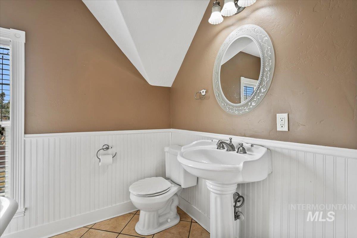 Bathroom featuring wainscoting and tile patterned floors