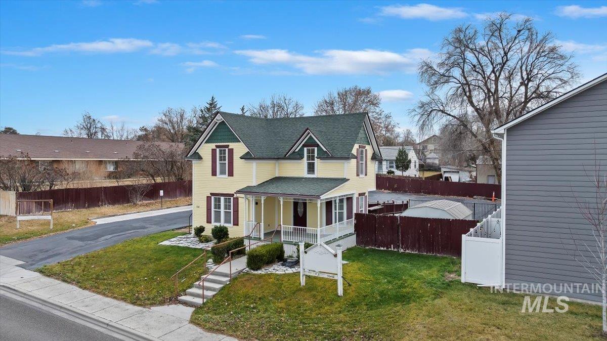 Victorian home with a porch and a shingled roof