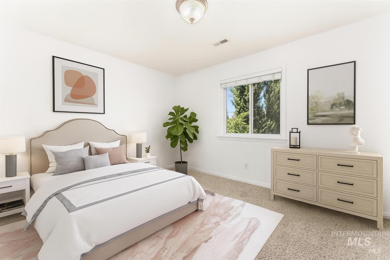 Bedroom featuring baseboards and light carpet