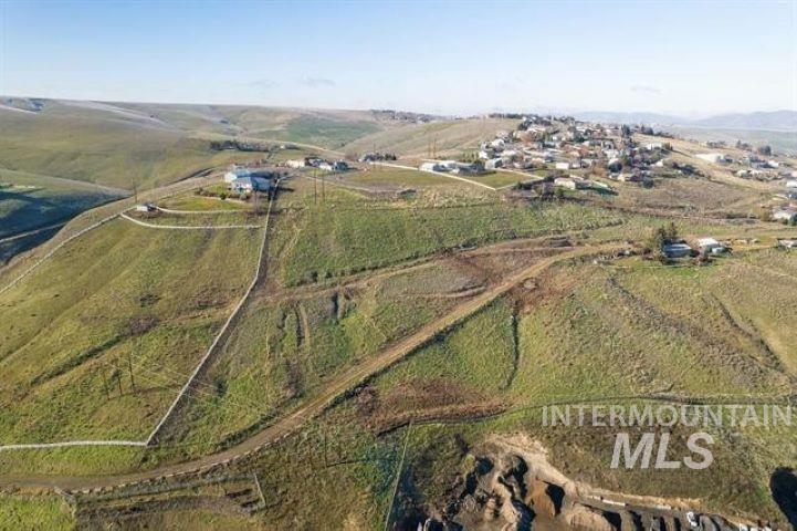 Aerial view of property and surrounding area featuring rural landscape
