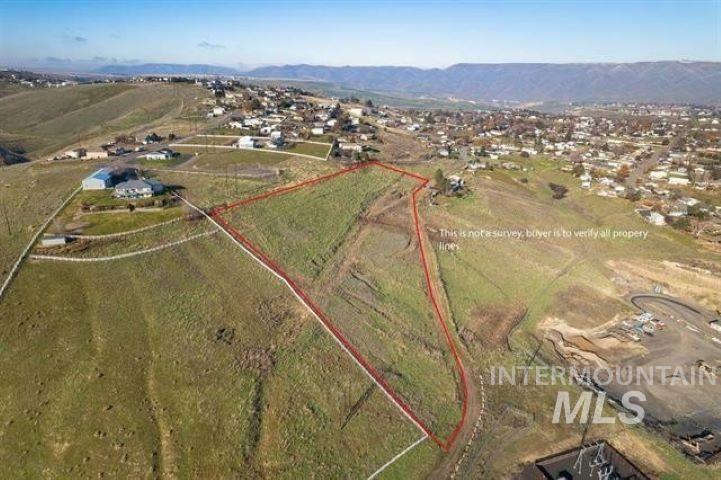 View of rural area featuring property boundaries highlighted and a mountain backdrop