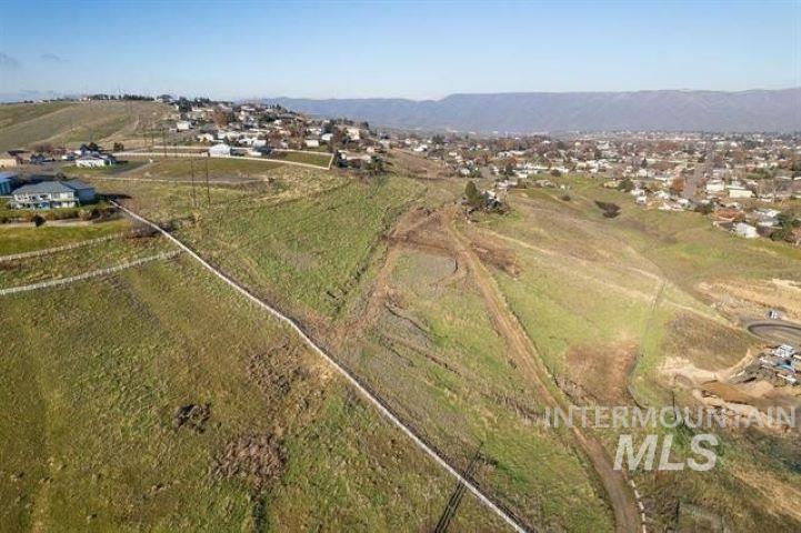 Aerial view of property's location with rural landscape and a mountainous background