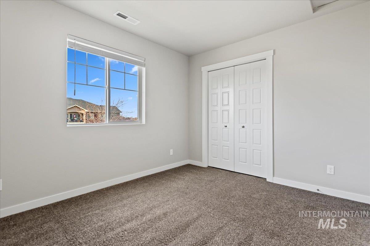 Unfurnished bedroom with carpet flooring and a closet