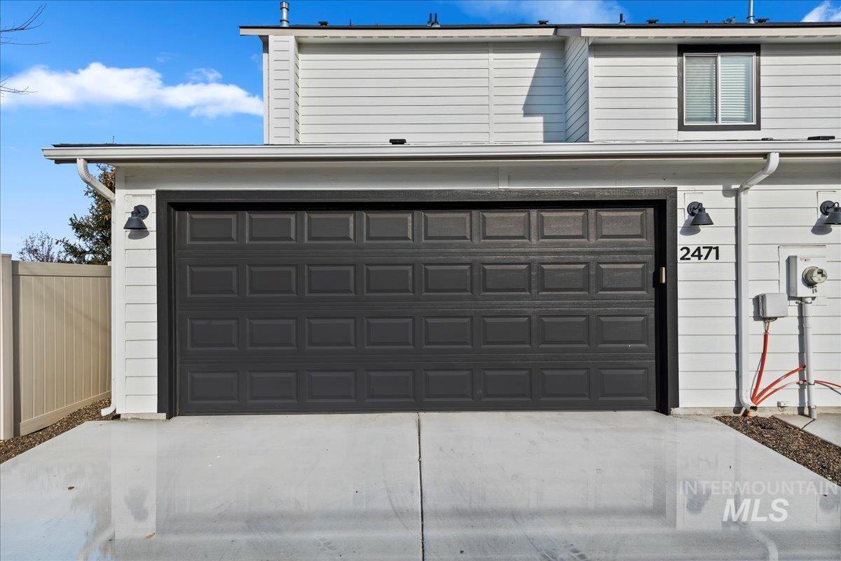 Garage featuring concrete driveway