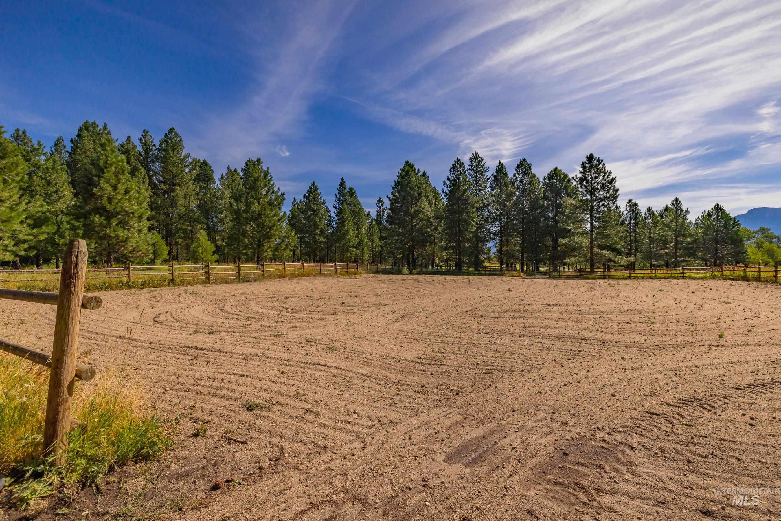 View of yard with an enclosed riding area and a view of rural / pastoral area